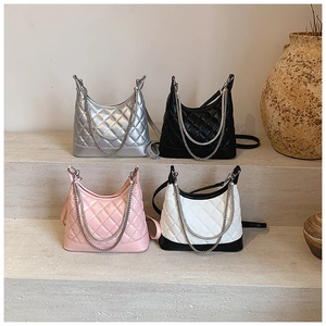 Detailed view of quilted faux leather hobo bags with silver chains in multiple colors