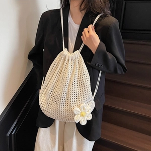 Chic hollow-out knit shoulder bag in cream with daisy detail shown on model