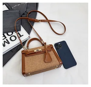 Mini straw and brown leather bag shown next to a smartphone to demonstrate actual size