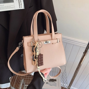 Pink lychee grain leather tote bag with metal twist lock and creative charm