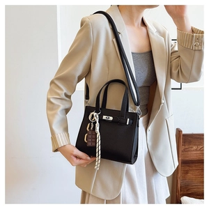 Classic black litchi pattern leather handbag with silver buckle and decorative charms