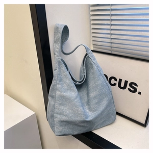 Detail of light blue tote bag with white speckled texture fabric and casual shoulder strap