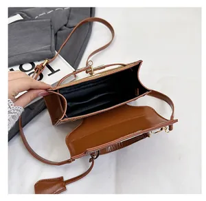 Top view of the brown leather shoulder bag interior showing spacious black fabric lining