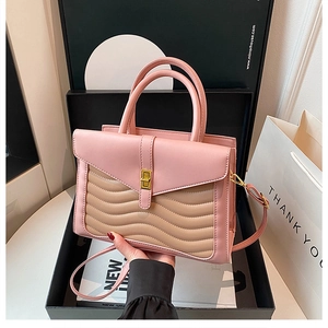 Pink and tan contrast tote bag with wave quilting and gold twist lock in luxury gift box
