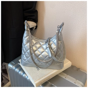 Detail of silver quilted hobo bag with pearl chain charms and metal hardware