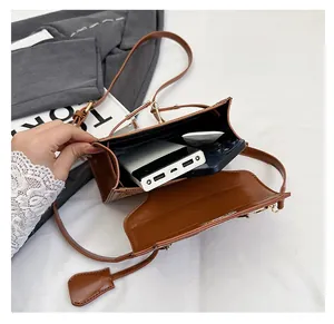 Top view of brown leather crossbody bag interior showing spacious storage for essentials