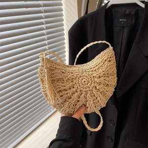 Handmade woven straw saddle bag with tassels for beach vacations and casual wear