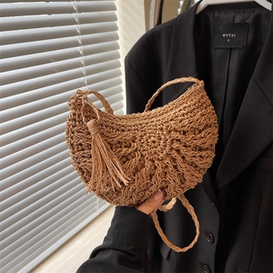 Handwoven straw crescent bag with tassels for summer beach and vacation styling