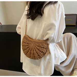 Handmade hollow woven straw crossbody bag in light brown for beach vacations