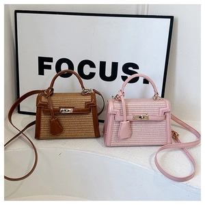 Detail of straw patchwork Kelly handbags in pink and brown with leather trim and top handles