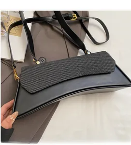 Detail of crescent shoulder bag featuring black matte finish and textured knit flap