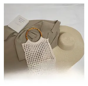 Detailed shot of hollow knit tote bag featuring round bamboo handles and ivory mesh texture
