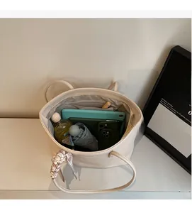 Detail view of large tote bag interior showing ample space for tablet and daily items