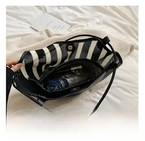 Interior detail of black leather tote bag showing large capacity and magnetic closure