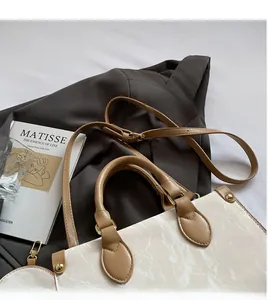 Detail of white marble textured tote bag with detachable round coin purse and brown strap
