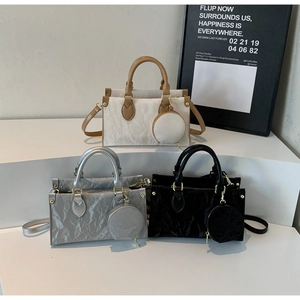 Three multi-color textured crossbody bags with round coin purses on a modern display