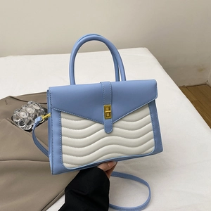 Fashionable blue and white patchwork shoulder bag with wave quilting and metal lock