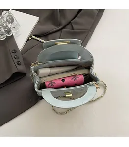 Detail view of light blue quilted bag interior showing space for phone and makeup