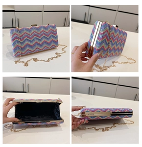Macro details of colorful woven clutch bag with gold frame and chain strap
