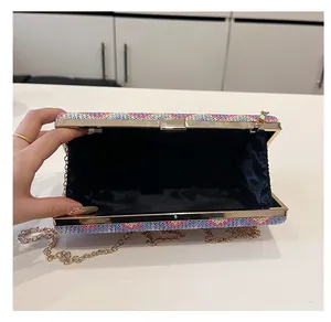 Detail view of woven evening bag interior showing blue satin lining and gold chain