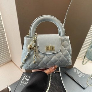 Quilted light blue leather handbag with gold chain strap and elegant turn-lock closure