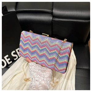 Detail of high-capacity woven bag with colorful zigzag pattern and gold metal snap closure