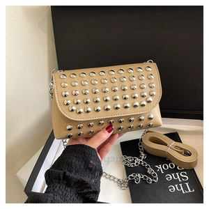 Detail of khaki rivet crossbody bag with silver studs and chain shoulder strap