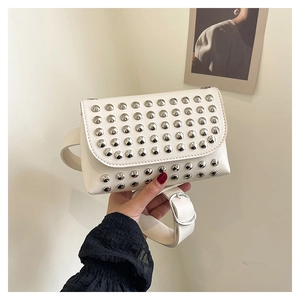 Detail of white leather shoulder bag with silver stud accents and wide adjustable strap