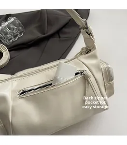 Detail of the back zipper pocket on this cream PU shoulder bag for small essentials