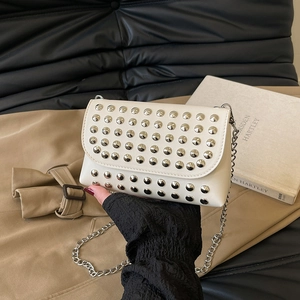 White leather shoulder bag with silver metallic studs and a delicate chain strap