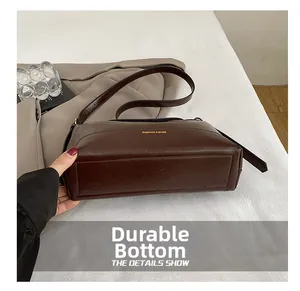 Close-up of the durable wear-resistant bottom on this dark brown leather tote bag