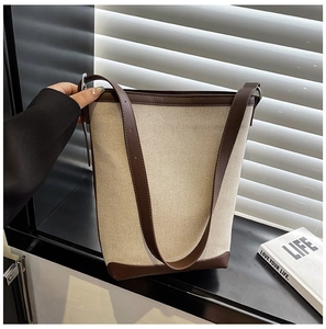 Detail showing the contrast canvas and leather trim on this stylish bucket bag design
