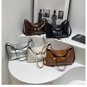 Showcase of five colored faux leather tote bags with gold hardware and flap closure