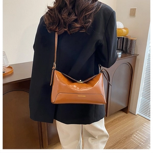 Detail view of brown glossy PU tote bag showing its large capacity and stylish texture