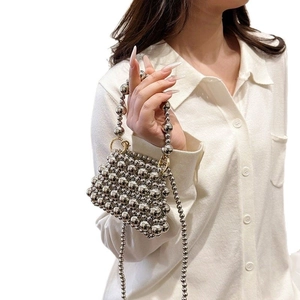 Silver beaded handmade crossbody bag with woven metallic pearls and top handle