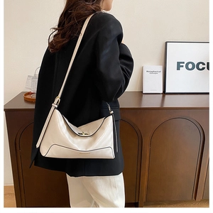 Detail of cream leather tote bag with gold twist lock and Fashion & Bags text logo