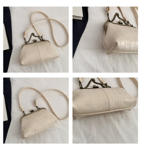 Detailed views of cream shell bag with crocodile texture and metal clasp closure