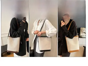 Detailed views of leather canvas bucket bags in three colors for versatile styling