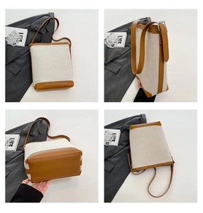 Detail view showing beige canvas and brown leather patchwork on the bucket shoulder bag