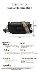 Detailed spec view of a black crossbody bag with a stylish patterned wide shoulder strap