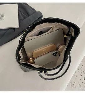 Detail view of large tote bag interior showing capacity for laptop and daily essentials