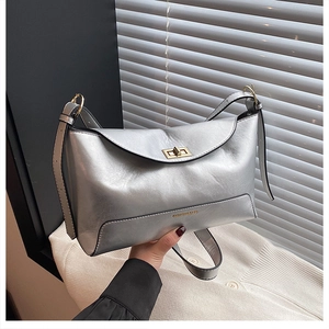 Detail of silver leather tote with gold twist lock and FASHION & BAGS lettering