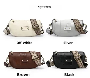 Four crescent crossbody bags in cream, silver, brown, and black with wide ethnic straps