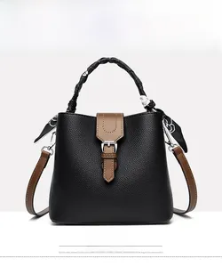 Detailed front view of black lychee grain bucket bag with silk scarf on handle