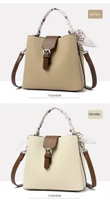 Detail of lychee pattern bucket bags in beige and white with floral scarf handles