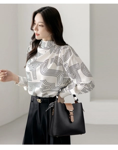 Detail of lychee pattern bucket bag with silk scarf on handle and stylish metal buckle