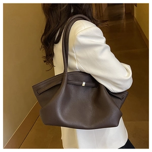 Detail der dunkelbraunen Leder-Shopper-Tasche mit Silberschnalle und natürlicher Narbung