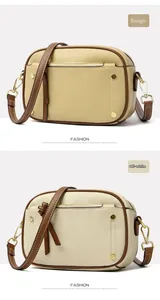 Detail view of lychee leather camera bags in beige and off-white with brown straps