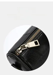 Close-up of premium black lychee leather bag with brushed gold zipper and hardware