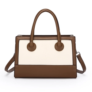 Retro-Handtasche aus braunem und cremefarbenem Leder mit Kugelgriff-Design